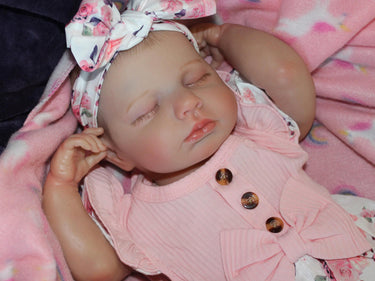 Doll with rotating arms and a rotating head with a cloth body and vinyl limbs. The hair is painted on the head.